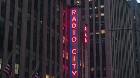 Radio-City-Music-hall-neon-sign-side-view-of-neon-lights,-night-time-city-glow