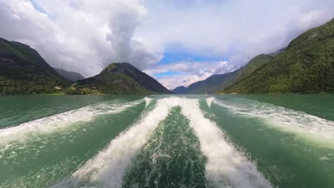 Waves-and-wake-behind-fast-moving-boat-in-Fjaerlandsfjorden-glacier-green-sea-Norway---Summer-wide-angle-sightseeing-boat-clip