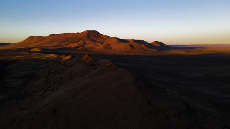 High-angle-panoramic-pan-shot-over-semi-desert-Karoo-landscape-at-sunset