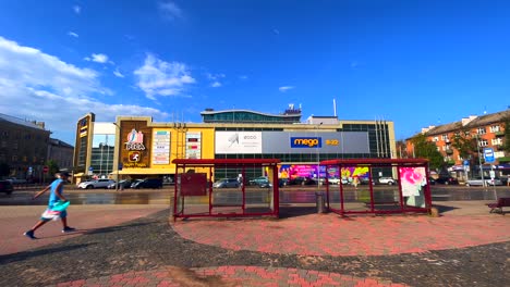 Man-searches-garbage-cans-in-front-of-Daugavpils-Solo-shopping-center