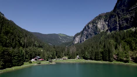 Forward-movement-showing-people-at-Montriond-lake-seen-from-above-with-mountain-rocks-rising-above