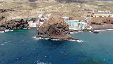 Roques-de-Fasnia,-Tenerife:-aerial-view-in-orbit-of-one-of-the-rock-formations-of-Fasnia-and-where-you-can-see-the-rocky-beach