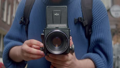 Close-Up-Shot-Of-Persons-Hands-Holding-Mamiya-Rb67-Analog-Film-Camera