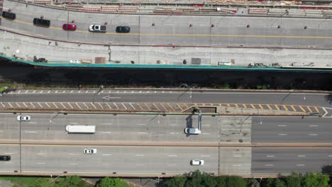 Overhead-of-moving-vehicle-traffic-on-New-York's-West-Side-Highway-and-Riverside-Dr,-4K-drone-shot