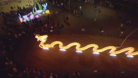 Sculptures-of-an-orange-long-dragon-and-a-sea-turtle-in-an-illuminated-exhibition-in-Tel-Aviv