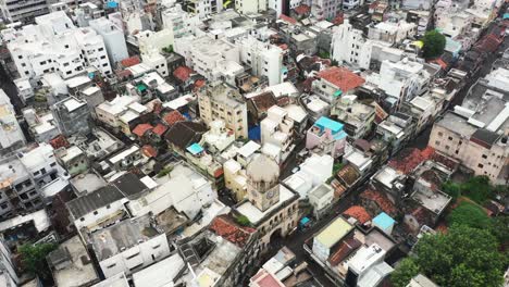 Aerial-Cinematic-View-of-Raya-Naka-Long-ago-this-clock-tower-was-the-main-gateway-to-the-city-but-now-it-is-surrounded-by-buildings-in-the-middle-of-the-city
