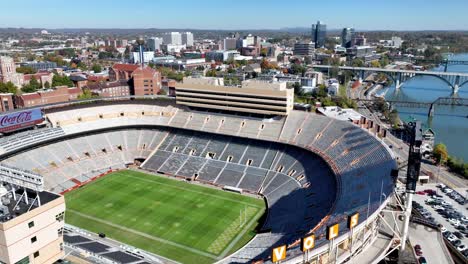 Luftstoß-über-Das-Fußballstadion-Von-Neyland-Mit-Der-Skyline-Von-Knoxville,-Tennessee-Als-Hintergrund