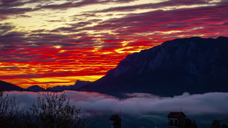 Red-sunset-sky-behind-mountains-in-Austria,-time-lapse-view