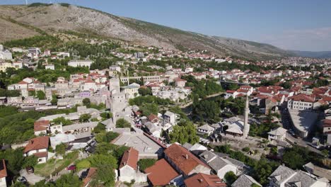 Picturesque-Mostar-nestled-among-mountains,-showcasing-architecture.-Aerial
