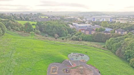 Drone-shot-of-a-green-area-in-Leeds,-landscape-time-shot-with-playground