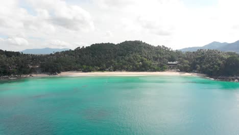 An-aerial-slow-reveal-of-Pansea-Beach-resort,-located-on-the-West-Coast-of-Phuket-in-the-southern-part-of-Thailand