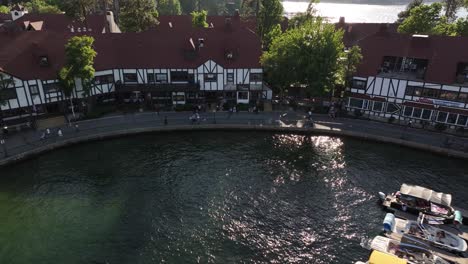 sun-setting-on-Lake-Arrowhead-Village-and-marina-AERIAL-DOLLY-BACK-RAISE