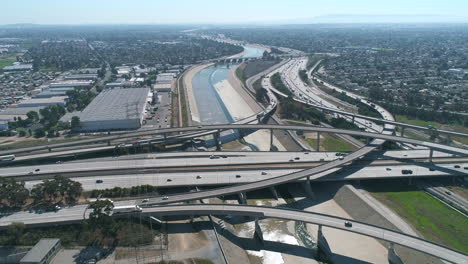 Aerial-drone-shot-of-710-Interstate-over-the-LA-River-in-California-with-cars-on-highway
