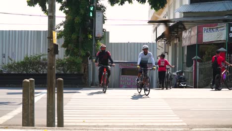 Two-adults-were-riding-bicycles-and-crossing-the-zebra-cross---Indonesia