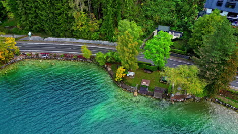 Coastal-road-and-township-near-Attersee,-aerial-drone-view