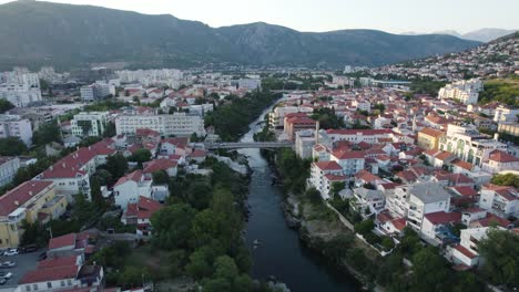 Mostar-Evening-Glow-by-Historic-Neretva-River,-Aerial-Fly-over