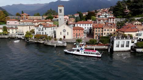 AERIAL---View-of-a-Boat-at-a-Pier-in-Torno,-Lake-Como