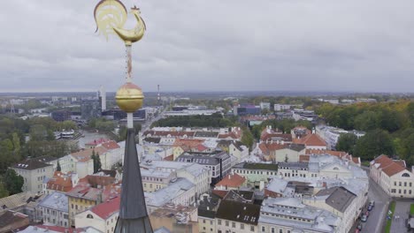 Golden-rooster-on-top-on-Jaani-church-in-Tartu,-drone-fly's-by-very-close