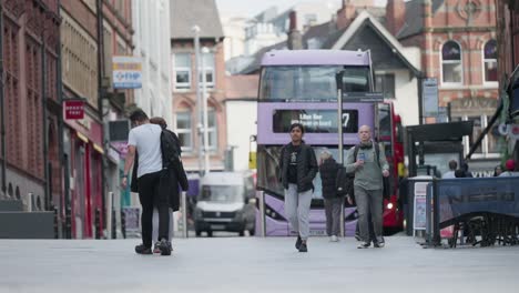 Street-level-slow-motion-scene-of-pedestrians-walking-the-streets-in-central-Nottingham