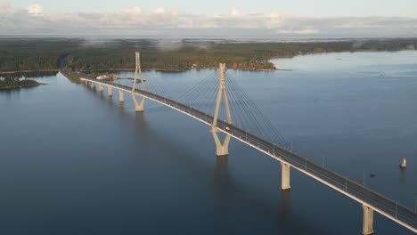 Spectacular-aerial-view-of-Replot-Bridge-cable-stayed-tuftform-bridge,-white-car