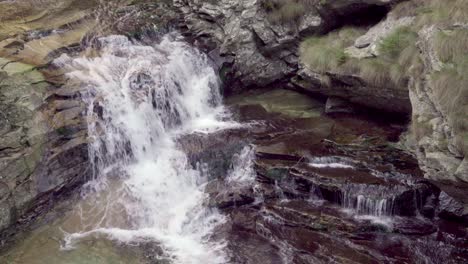 A-small-waterfall-near-Campliccioli-lake-in-the-Antrona-Valley-Natural-Park-in-the-Verbano-Cusio-Ossola-province-in-Piedmont,-Italy