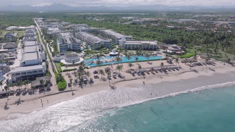 Aerial-View-Of-Luxury-Beachfront-Hotels-On-A-Sunny-Day-In-Summer-In-Punta-Cana,-Dominican-Republic