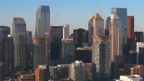 A-aerial-drone-slowly-pulls-back-revealing-the-downtown-core-of-Calgary-Alberta