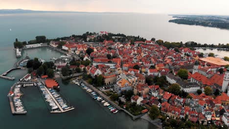 Panoramic-view-of-the-town-and-island-of-Lindau,-Germany-on-Lake-Constance-during-sunrise-in-4K