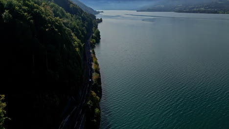 Aerial-drone-shot-following-a-car-riding-on-a-scenic-coastal-highway