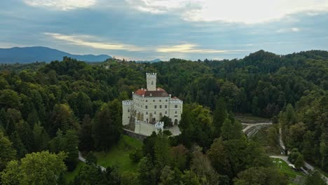 Trakoscan-Castle-Surrounded-By-Lush-Vegetation-In-Croatia---aerial-drone-shot