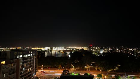 Kingsford-Smith-Sydney-Airport-at-night-from-a-balcony,-timelapse-of-car-traffic-and-airplanes