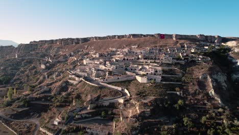 Aerial-drone-forward-moving-shot-over-Urgup-Town-houses-along-Temenni-Hill-in-Cappadocia-Region-of-Turkey-at-daytime