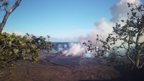 Gimbal-wide-panning-shot-of-the-crater-at-Kilauea-erupting-in-September-2023-with-trees-in-the-foreground-on-the-Big-Island-of-Hawai'i