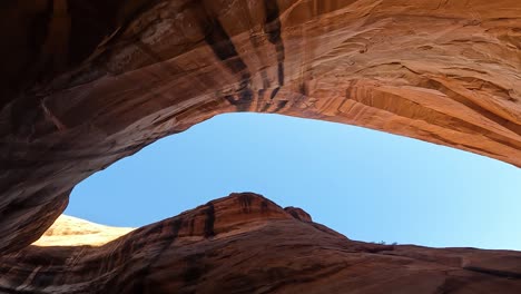 Stunning-POV-view-inside-deep-Glen-Canyon-rock-walls-and-clear-blue-sky