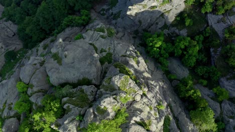 Aerial-top-down-shot-of-rocky-Rhodope-Mountains-during-sunny-day-in-Bulgaria,-Europe