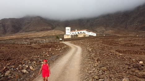 A-woman-in-a-red-dress-walking-down-the-road-from-Casa-Winter-Museum