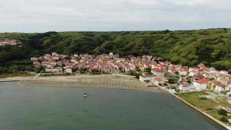 A-drone-shot-of-an-island-village-near-a-sandy-beach