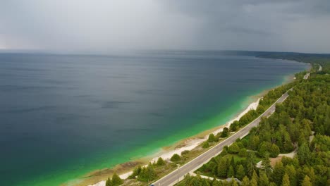 Aerial-view-of-an-ocean-road-with-an-incoming-storm-in-the-background
