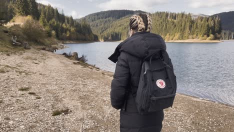 A-Girl-With-A-Backpack-Near-Bolboci-Lake-In-Romania