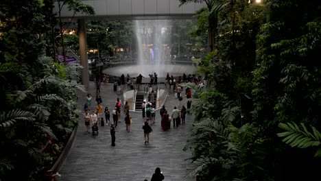 Pan-Up-View-Of-Visitors-At-The-Rain-Vortex-At-Jewel-Changi-Airport-In-Singapore