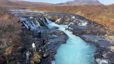 Tourists-walking-and-taking-pictures-in-Bruarfoss-blue-river