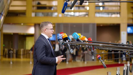 Finish-Prime-Minister-Petteri-Orpo-talking-to-the-press-at-the-European-Council-summit-in-Brussels,-Belgium---Profile-shot