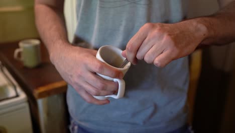 Stirring-contents-of-mug