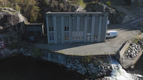 Norway-Hydroelectric-powerplant-on-Fossmark,-backward-aerial-revealing-turbine-outlet-water
