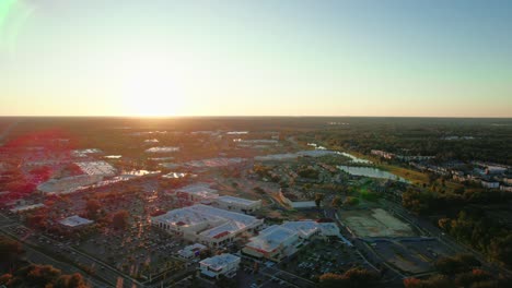 Aerial-shot-of-Gainesville-city-with-sunset-sky-in-the-background,-Florida,-USA