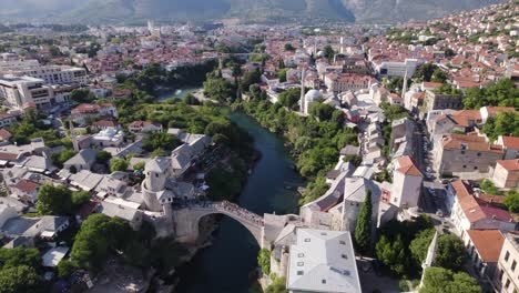 Aerial-Fly-over-of-Stari-Most-Bridge,-Mostar-cityscape,-Bosnia