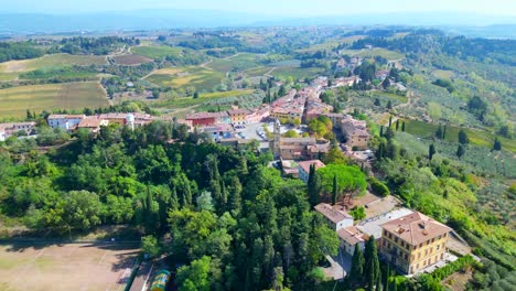 Magic-aerial-top-view-flight-Tuscany-Medieval-Village-Mediterranean-Wine-growing-region-wide-orbit-overview-drone