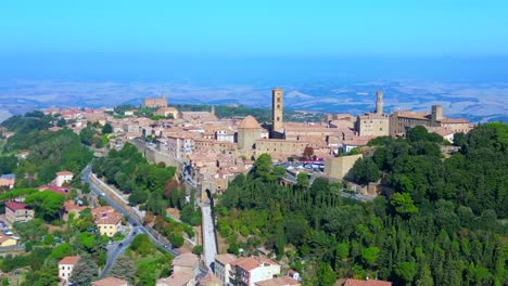 Smooth-aerial-top-view-flight-Volterra-Tuscany-Medieval-hill-town,-city-walls-Italy-Tuscany
