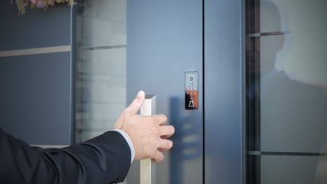 A-man-using-biometric-fingerprint-sensor-for-open-smart-home-door