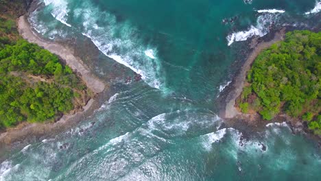 Flying-straight-up-from-the-blue-ocean-water-flowing-between-islands-off-the-shore-of-Costa-Rica-island-Playa-Herradura